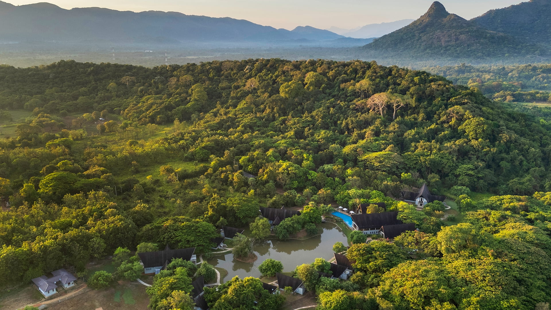 Broad overview of the misty hills and the greenery surrounding Oak Ray Liyya Water Villas Dambulla
