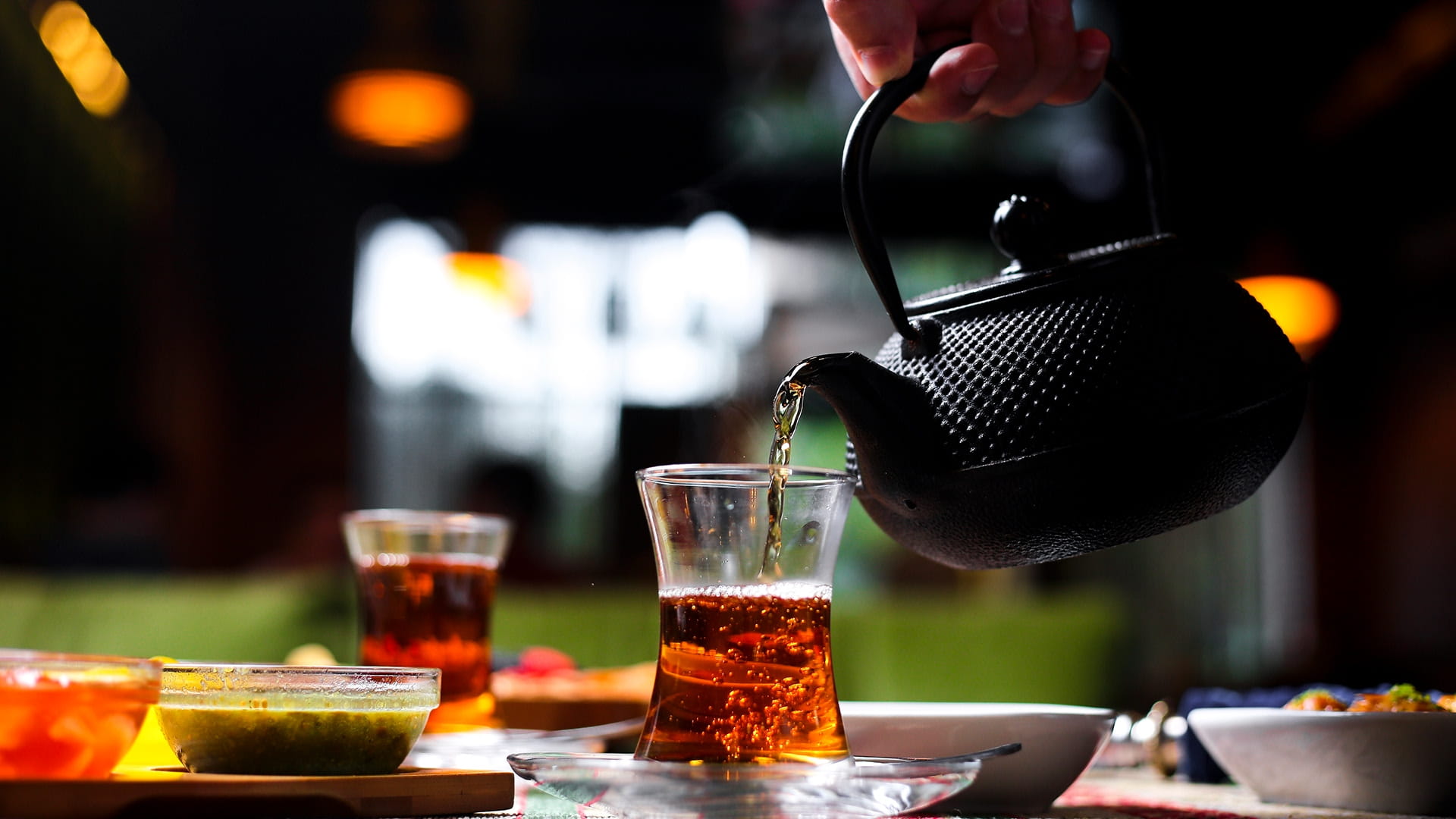 Tea being poured into a cup 